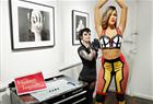 Tattoo artist Jessica V. poses with never before seen Madame Tussauds New York wax figure of singer Rihanna as it is unveiled at famed SOHO tattoo parlor Sacred Tattoo on on July 11, 2013 in New York City.